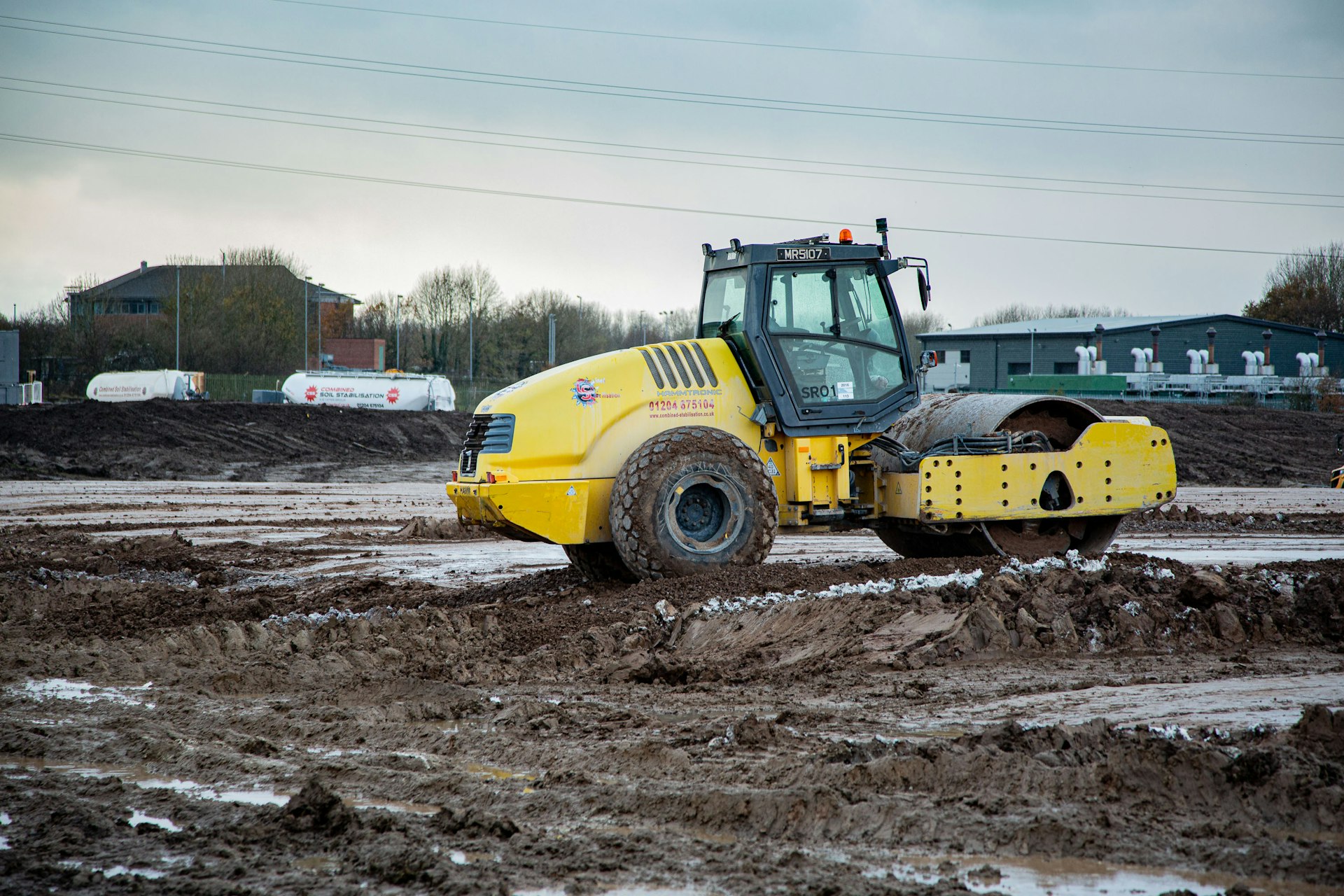 a tractor is driving through a muddy field